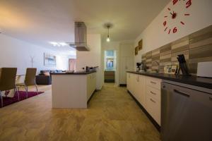 a kitchen with a counter and a living room at Calle Lanzarote 29C in Playa del Ingles
