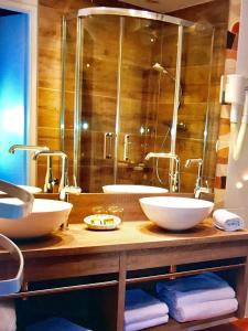 a bathroom with two sinks and a large mirror at Castel Damandre in Arbois