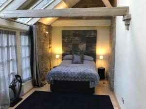 a bedroom with a bed and a large window at Hemples Lodge in Newcastle upon Tyne