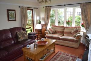 a living room with a couch and a coffee table at Sunnycroft in Sutton on Sea