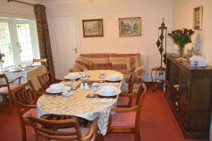 a living room with a table and a couch at Sunnycroft in Sutton on Sea
