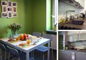 uma cozinha com paredes verdes e uma mesa com frutas em Marilyn Apartment em Lódź