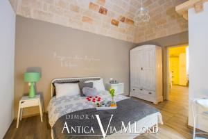 A bed or beds in a room at Dimora Antica Via MiLord