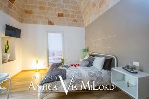 A bed or beds in a room at Dimora Antica Via MiLord