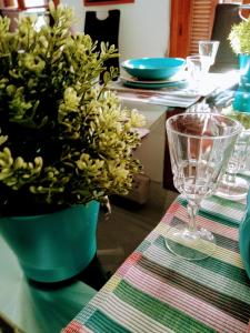 a table with a green vase with a plant on it at Turquesa de Sevilla Suite in Seville