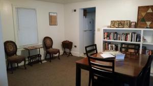 a dining room with a table and chairs and a refrigerator at Pearl's Place in Gettysburg