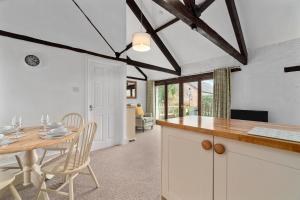 a kitchen and dining room with a table and chairs at Mill Cottage in Paignton