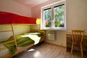 a bedroom with a bunk bed and a desk and a chair at Luna in Mielenko