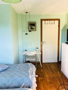 a bedroom with a bed and a table and a door at B&B Ishoej Private bath in Ishøj