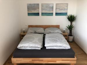 a bedroom with two beds and two paintings on the wall at High 5 in Graz