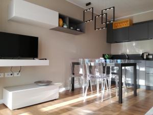 a kitchen with a table and chairs and a television at Casa Lu in Levico Terme