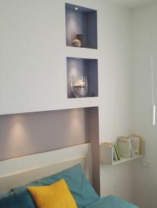 a bedroom with a bed and shelves on the wall at Casa Lu in Levico Terme