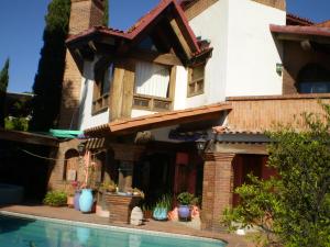a house with a swimming pool in front of it at Casa Paanoramica in Valle de Bravo