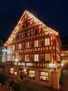 
a large building with a clock on the front of it at Hotel-Restaurant Ochsen in Blaubeuren
