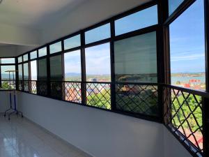 a balcony with windows and a view of the city at Town City Home sweet home in Kuala Terengganu