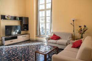 a living room with two couches and a tv at Nunziata Apartment in Genova