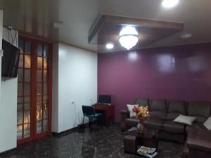 a living room with a couch and a desk at Hotel Gun Glub in Bogotá