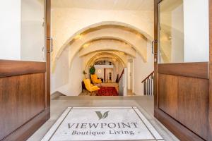 a view of the front door of a building with a welcome mat at Viewpoint Boutique Living in Xlendi