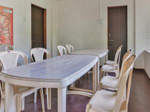 a table and chairs in a room with a table at Bahar Deluxe in Dapoli