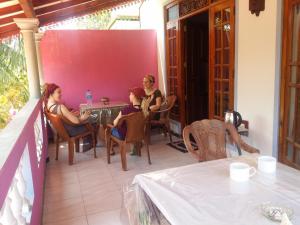two women sitting at a table on a patio at Shasee Rest-Mirissa in Mirissa