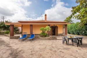 a patio with chairs and a table and a house at Holiday home in Santa Maria La Palma 31431 in Santa Maria la Palma