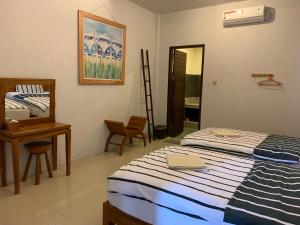 Rúm í herbergi á Lazy Inn Kuta Lombok