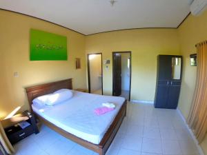 Säng eller sängar i ett rum på Bali Fab Dive Center