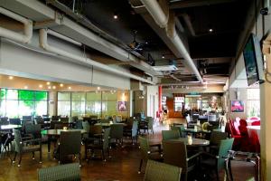 a dining room with tables and chairs in a restaurant at Gold Coast Morib Mickey House in Banting