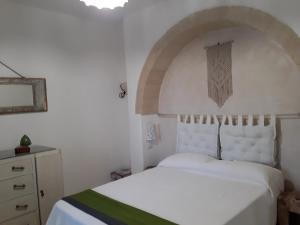 A bed or beds in a room at Trullo Cime Bianche