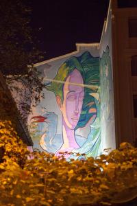 a painting of a woman on the side of a building at Tuzla Garden Hotel & Spa in Tuzla