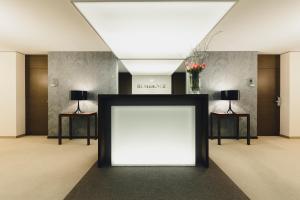 a blank white sign in a room with two lamps at Residence Hotel in Vaduz