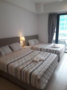 Ένα ή περισσότερα κρεβάτια σε δωμάτιο στο Holiday Home @ Midhills Genting