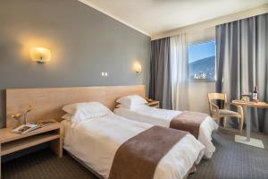 Postel nebo postele na pokoji v ubytování Nestos Hotel