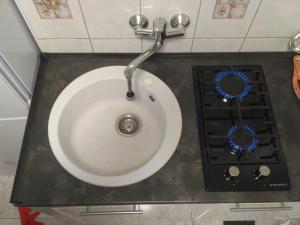 a bathroom with a sink and a stove at Valloris Apartments in Hévíz