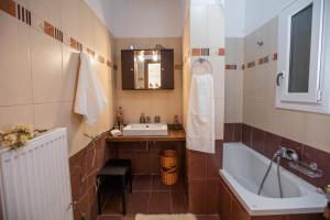 a bathroom with a sink and a bath tub at Elisso Apartment in Argostoli +37 photos