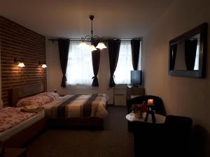 Postel nebo postele na pokoji v ubytování Penzion - Restaurant U Zámku