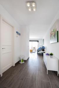 sala de estar con paredes blancas y suelo de madera dura en The Colors House, 629 - Private Apartment en Costa Teguise