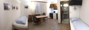 ein kleines Zimmer mit einem Tisch und einer Küche in der Unterkunft Ferienwohnungen Kössl in Waidhofen an der Ybbs