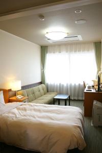 Łóżko lub łóżka w pokoju w obiekcie Miyamaso