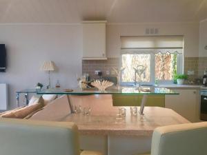 a kitchen with a counter with a glass counter top at Otter Lodge Auchterarder in Auchterarder