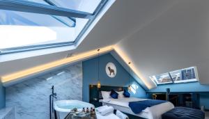 a attic bedroom with a bed and a tub and a sink at Moon and Chalice Boutique Hotel in Kunming