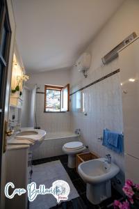 a white bathroom with a sink and a toilet at Casa Bellavista in Furore