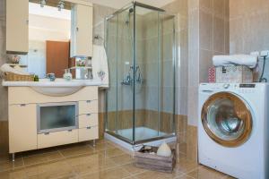 a bathroom with a shower and a washing machine at VILLA MARITINA in Kefallonia +36 photos