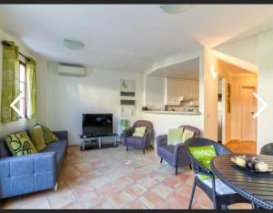 a living room with a couch and chairs and a table at Benidorm holiday rental in Cala de Finestrat