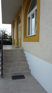 a building with stairs and a window on it at Marko Airport Rooms in Velika Gorica