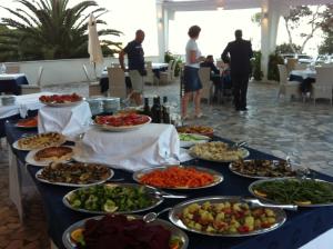 a table with many plates of food on it at Hotel Eden in San Domino