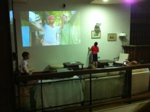 a group of people in a room with a projection screen at Hotel Eden in San Domino