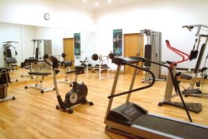 a gym with several treadmills and exercise bikes at Lahami Bay Resort in Abū Ghuşūn