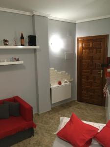 a living room with a red couch and a door at Denia Playa I in Denia