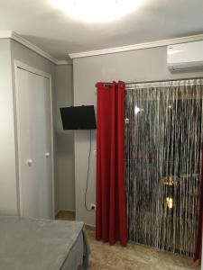 a bedroom with a red curtain and a shower at Denia Playa I in Denia